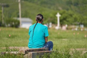 A man man sits and prays at the field where the remains of over 750 children were buried on the site of the former Marieval Indian Residential School in Cowessess First Nation, Saskatchewan, June 25, 2021. - More than 750 unmarked graves have been found near a former Catholic boarding school for indigenous children in western Canada, a tribal leader said Thursday -- the second such shock discovery in less than a month.
The revelation once again cast a spotlight on a dark chapter in Canada's history, and revived calls on the Pope and the Church to apologize for the abuse suffered at the schools, where students were forcibly assimilated into the country's dominant culture. (Photo by Geoff Robins / AFP) (Photo by GEOFF ROBINS/AFP via Getty Images)